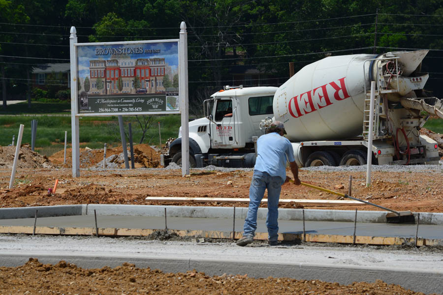 Crews Brush wet concrete Parking Spaces at the 5 Unit Brownstone Site