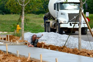 A Craftsman from John Russell's crew carefully sculps the new sidewalks along Dewitt Drive