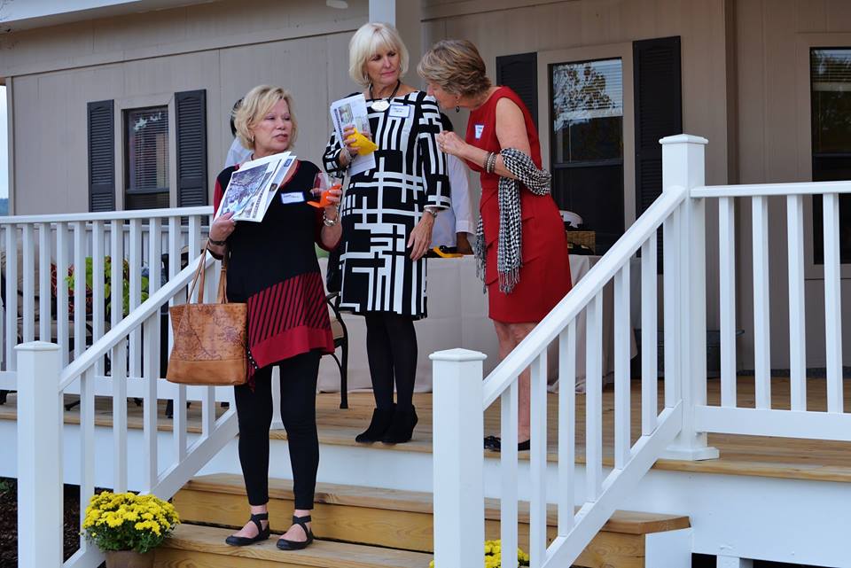 03. Some Preview Party guests pause with LENDON materials on the steps of the Welcome Center porch. _n